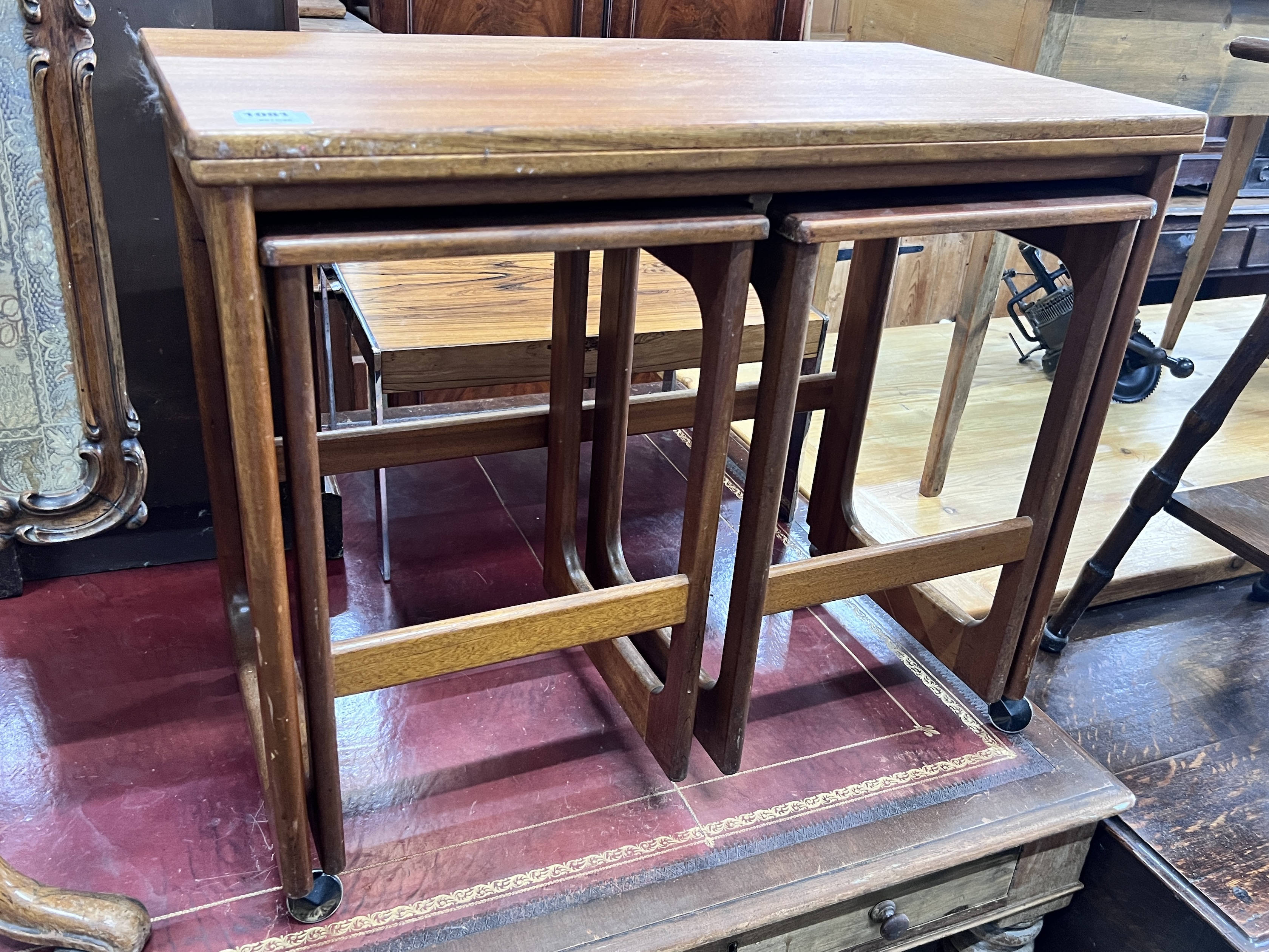 A nest of three G Plan teak tea tables with hinged swivel top, width 76cm, depth 40cm, height 64cm